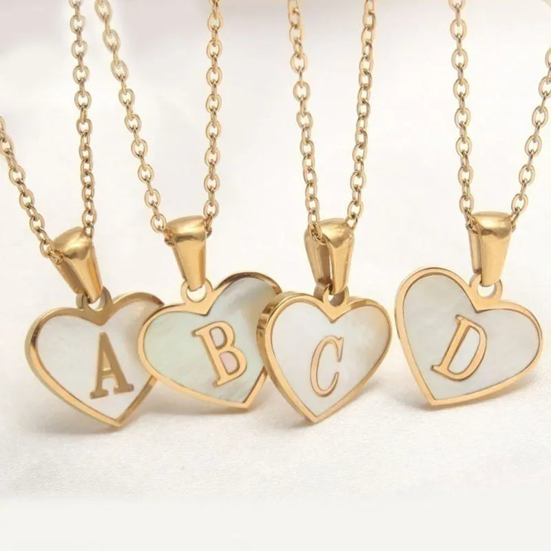 Personalised white shell heart necklace with gold chain and initial letter engraving