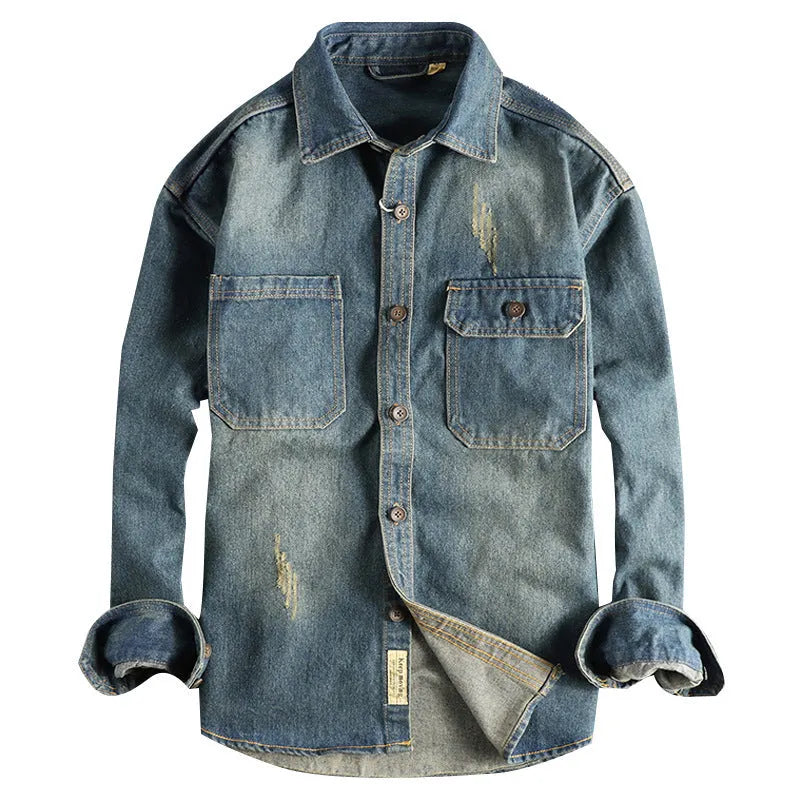 Men's light blue washed vintage denim shirt with a loose fit and long sleeves on a hanger.