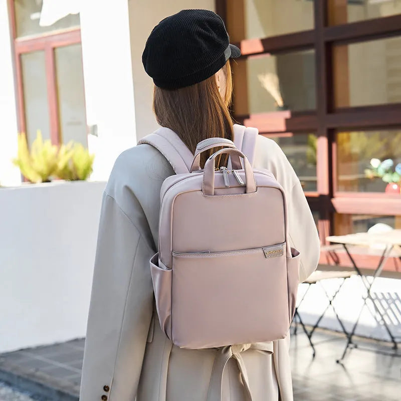 Simple canvas women's backpack in apricot colour showing internal organiser compartments and external pocket.