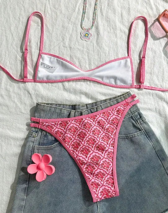 Printed pink split bikini set with exposed back and adjustable shoulder straps on woman