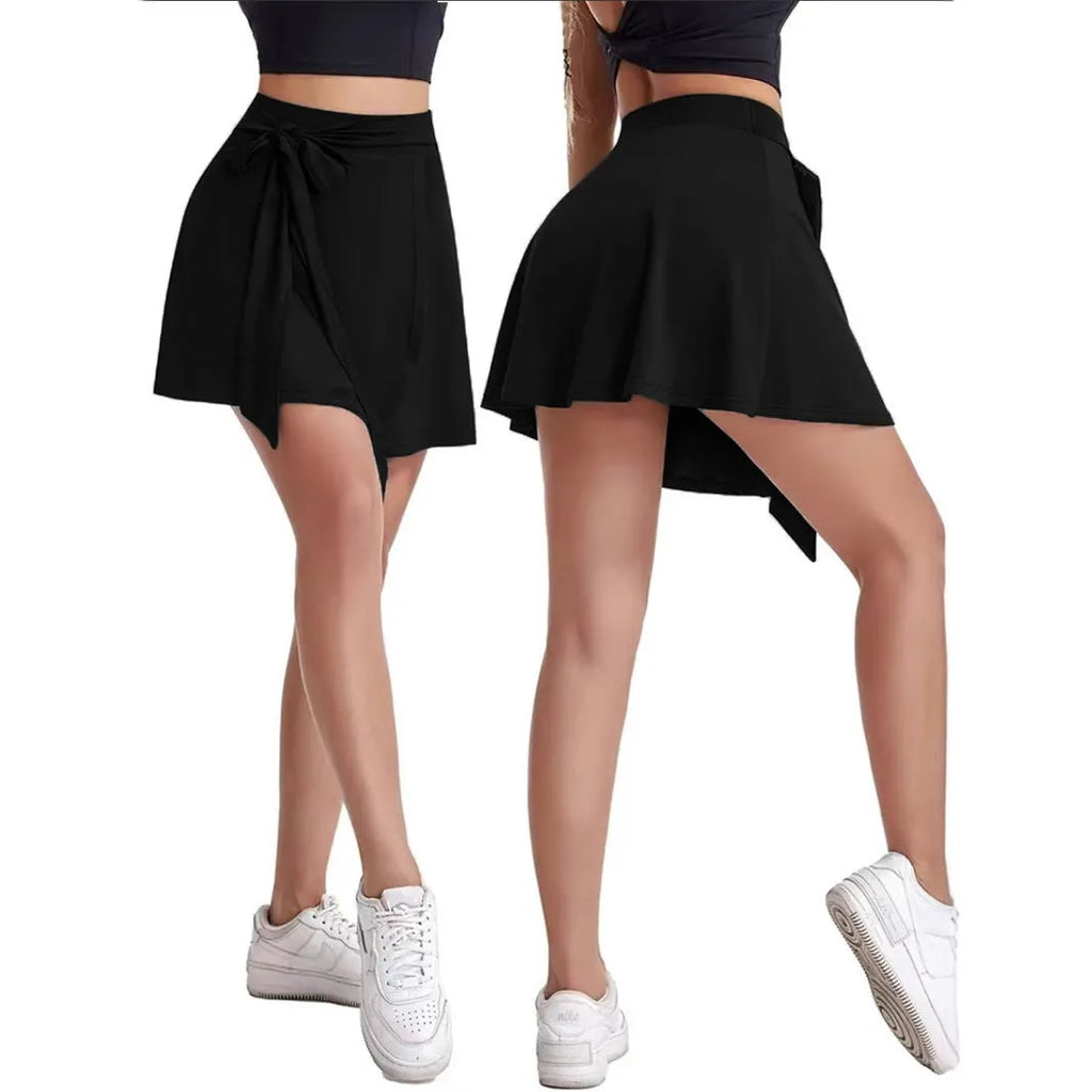 Black thigh-length sports skirt with built-in shorts and shoulder strap detailing