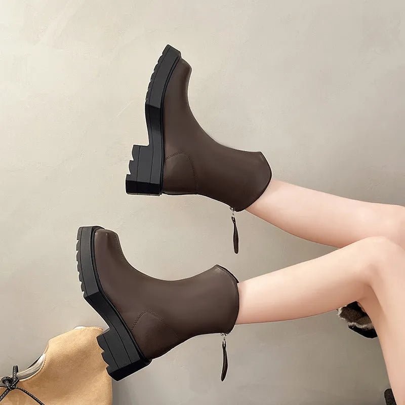 Black women's platform Martin ankle boots with a square toe and high heel on a white background