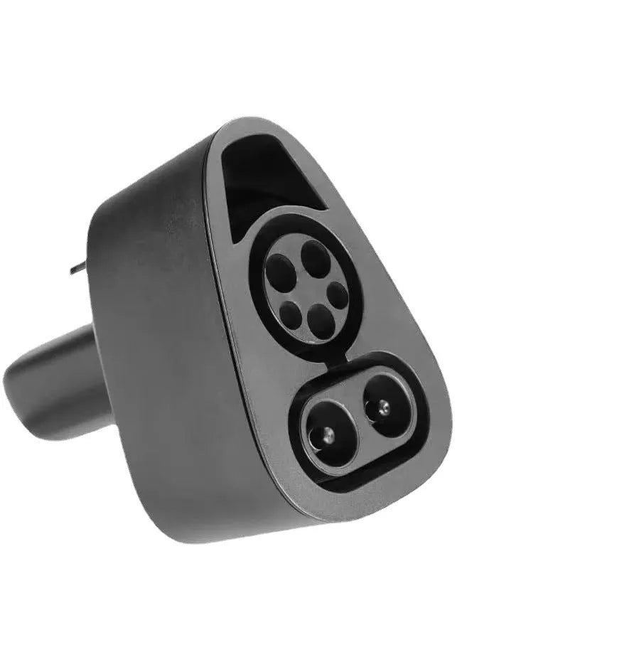 Black Tesla charging plug conversion adapter showing connector interfaces and housing