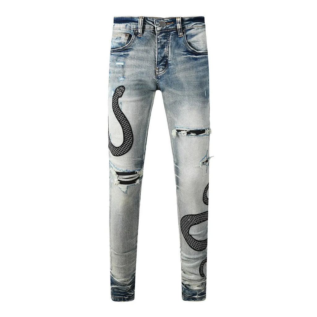 Distressed blue skinny jeans with wash detailing and button fly on mid waist design