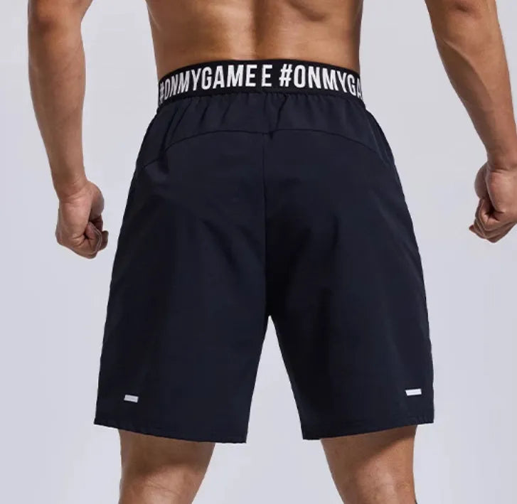 Men's loose sports shorts in black with elastic waist and printed letter details