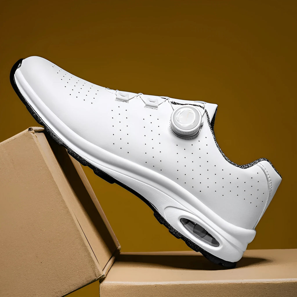 Low-top black and white mesh casual shoes with cross shoulder strap and round toe on a composite sole.