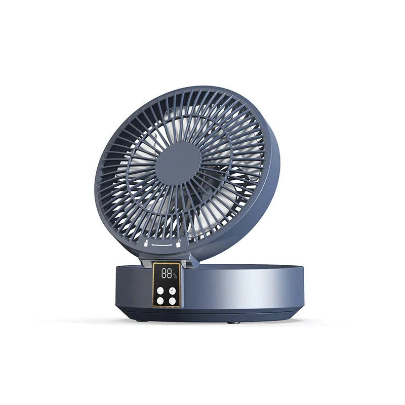White portable folding fan with remote control and warm night light on a desk.