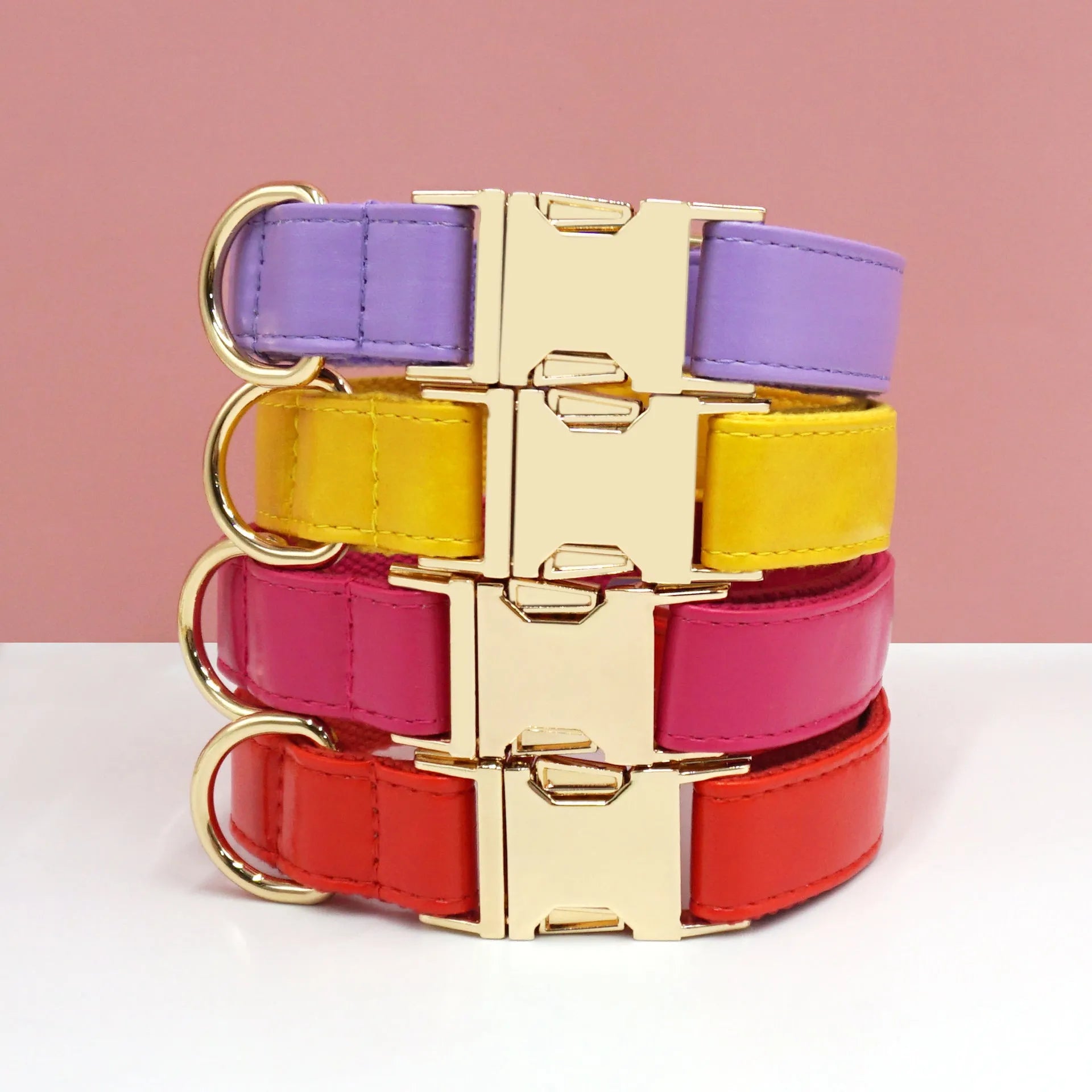 Solid colour leather dog collar shown in a selection of hues including caramel, dark blue and rose pink.