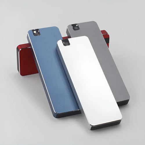 White portable external SSD with metal shell and USB cable next to a laptop.