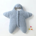 Baby lamb velvet starfish sleeping bag in khaki, hooded with zip and cuffs, lying flat on a surface