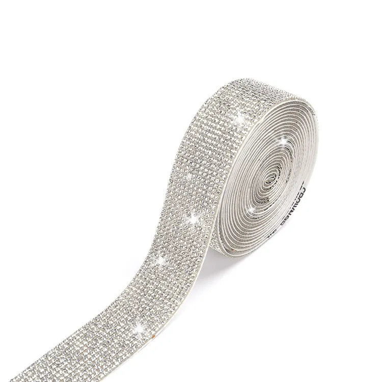Close-up of a self-adhesive electroplated glass crystal strip on a roll for clothing decoration.