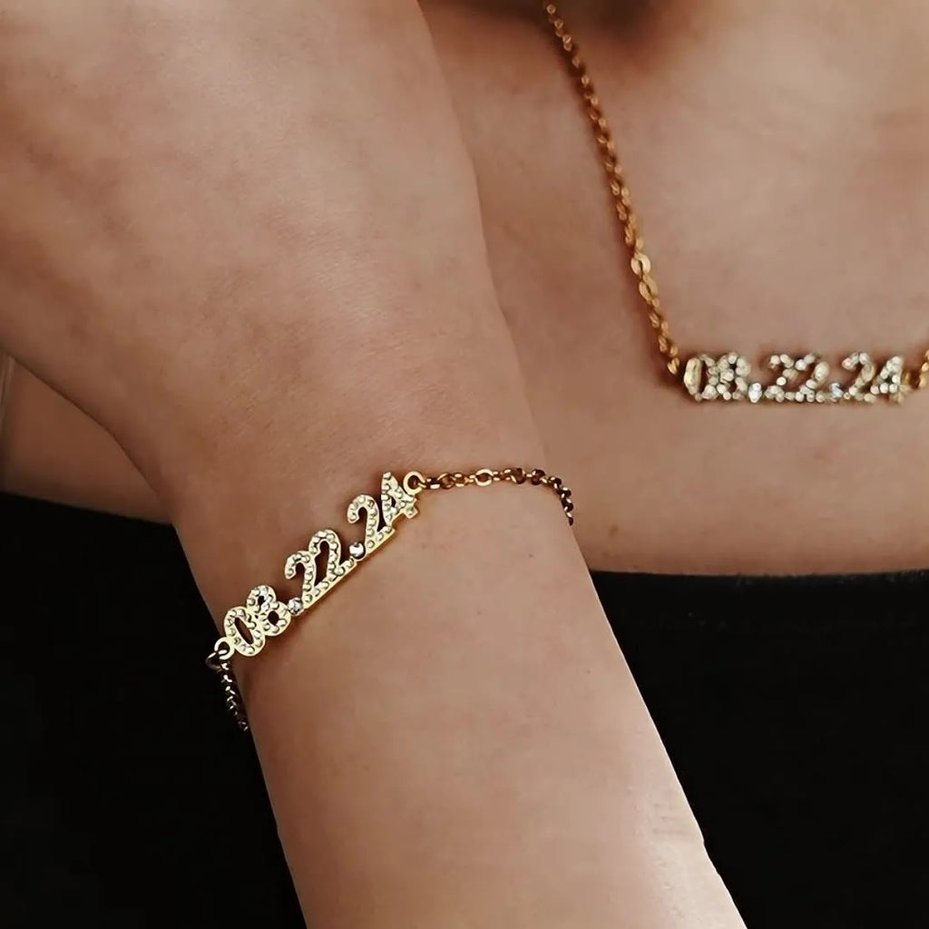 Stainless steel digital bracelet and necklace with diamonds on the numbers, shown in gold, rose gold and steel colour options.