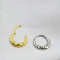 Close-up of a carved concave-convex titanium nose ring in silver finish