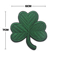 Outdoor embroidered fabric badge with green clover design on a velcro strip backing.