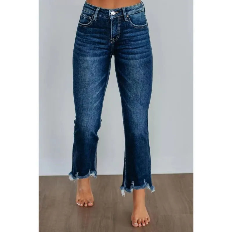 Women's solid colour cotton denim jeans with a hand-worn finish in dark blue.