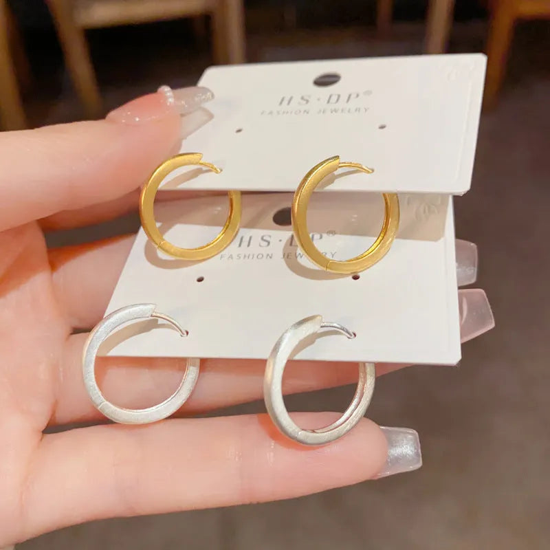 Women's geometric round ear clips with gold plating on copper in gold and silver colour options