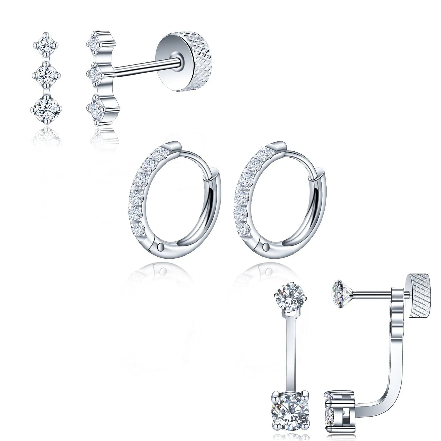 Three pairs of titanium steel ring-shaped geometric stud earrings with zircon inlay on a grey surface in steel and gold tones.