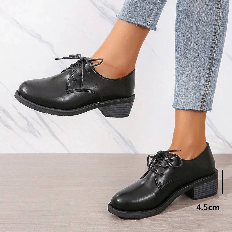 Black women's low-top shoes with a thick chunky heel and rubber sole.