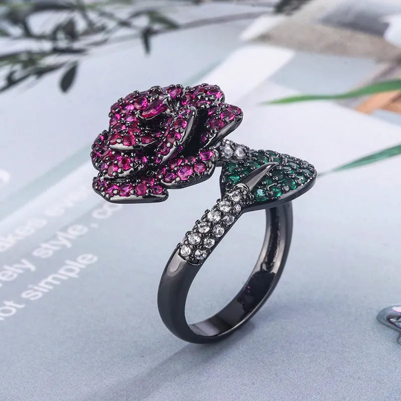Women's geometric flower ring in black gold with simulated red corundum stone on gold-plated copper band