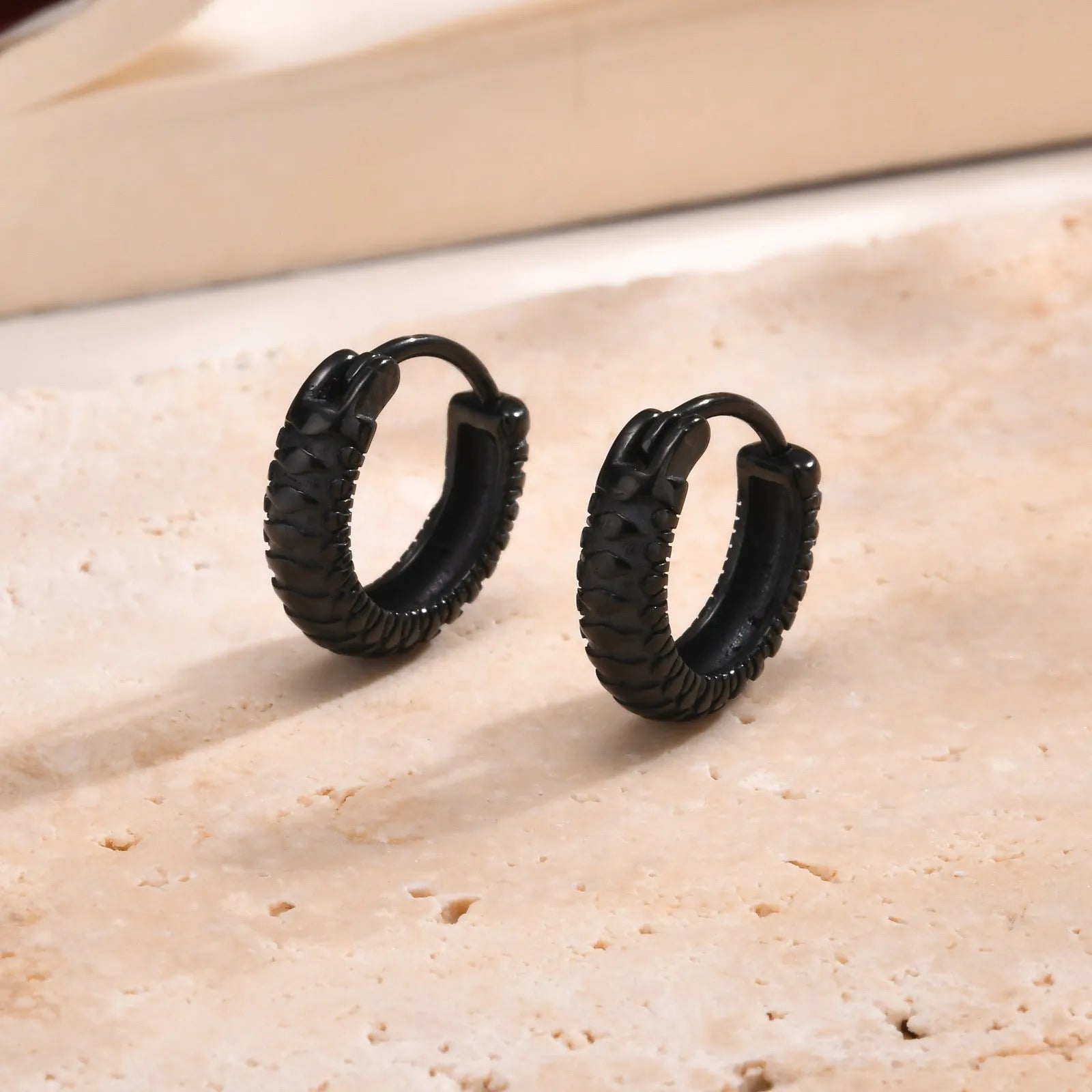 Stainless steel snake pattern earrings in black or gold colour options