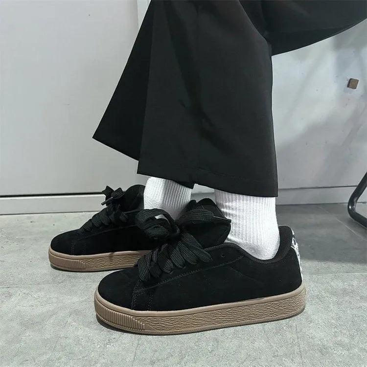 Black retro low-top sneakers with lace-up front, waterproof platform, and round toe design