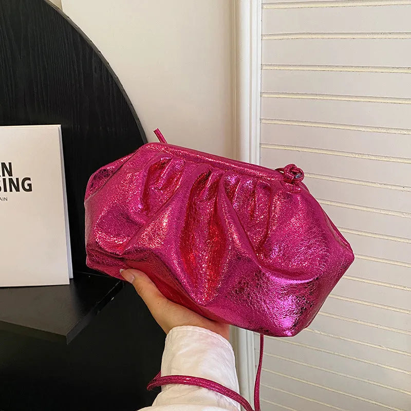 Simple hair clip shoulder crossbody bag in shell shape, showing rose red colour with visible sewing lines.
