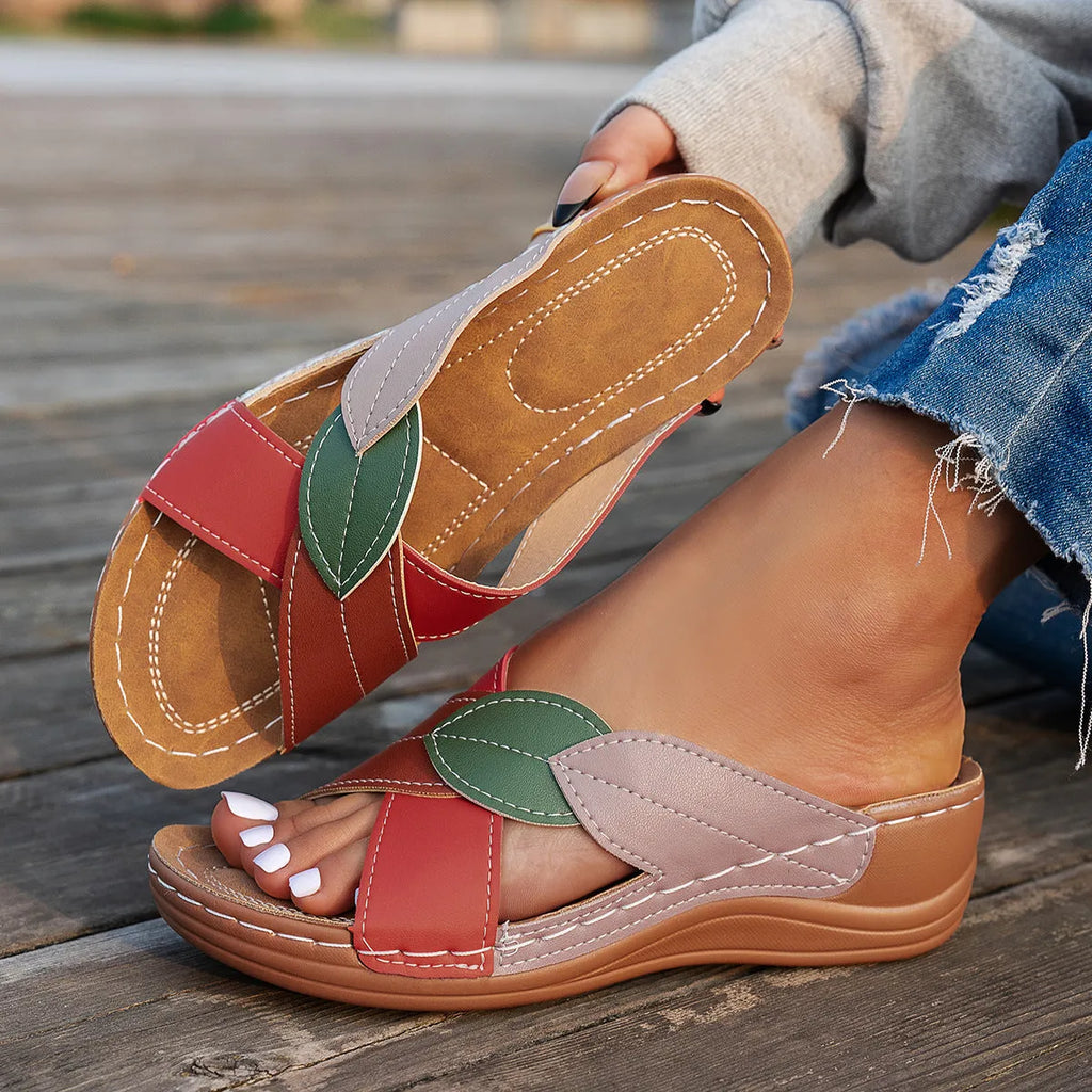 Women's black cross-strap peep-toe slippers with a thick polyurethane sole on a white background.