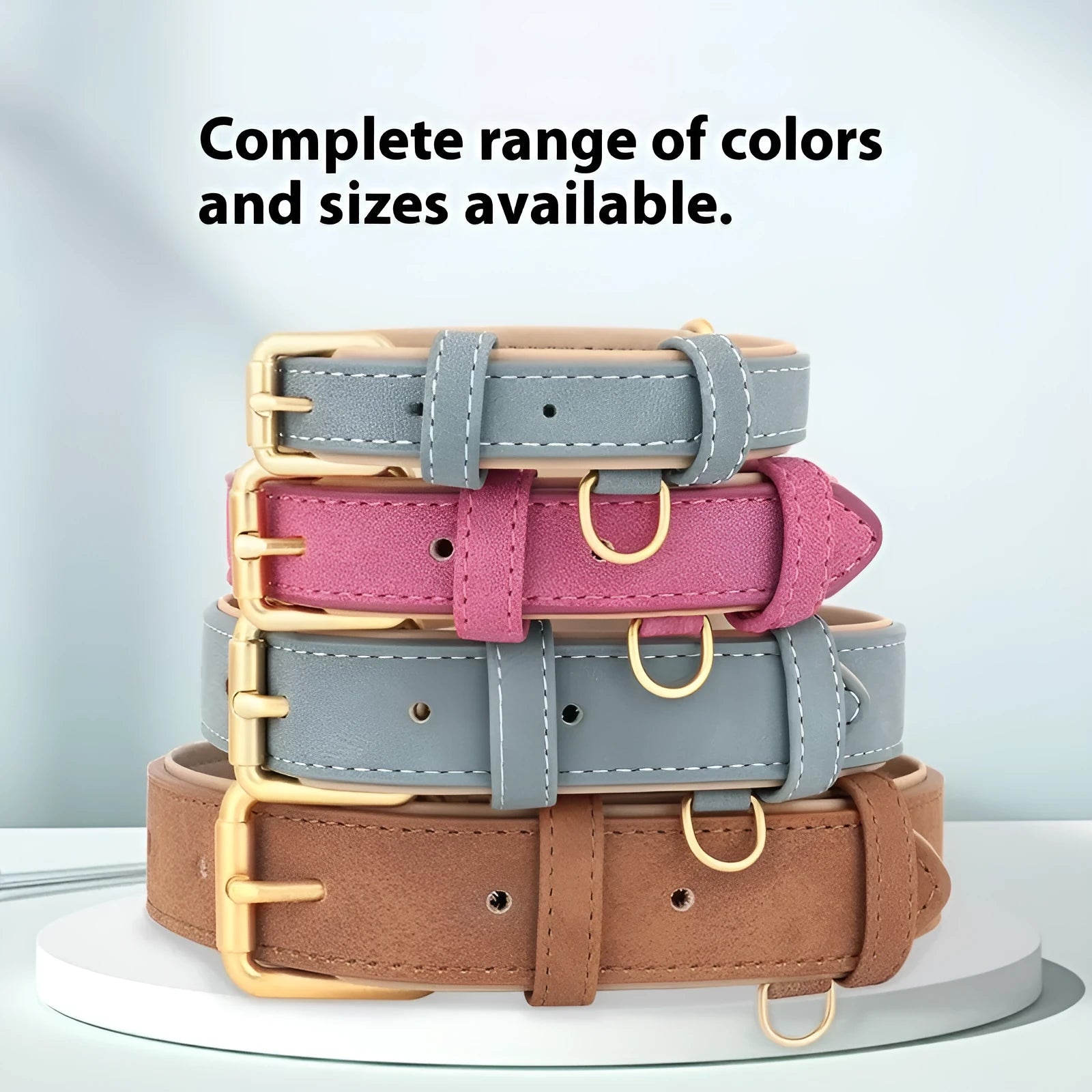 Brown double-layer leather dog collar with metal buckle and matching traction rope on a table