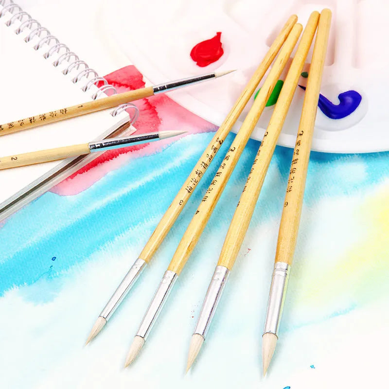 Six wooden-handled pointed pen brushes for wool and fabric crafts laid out together.