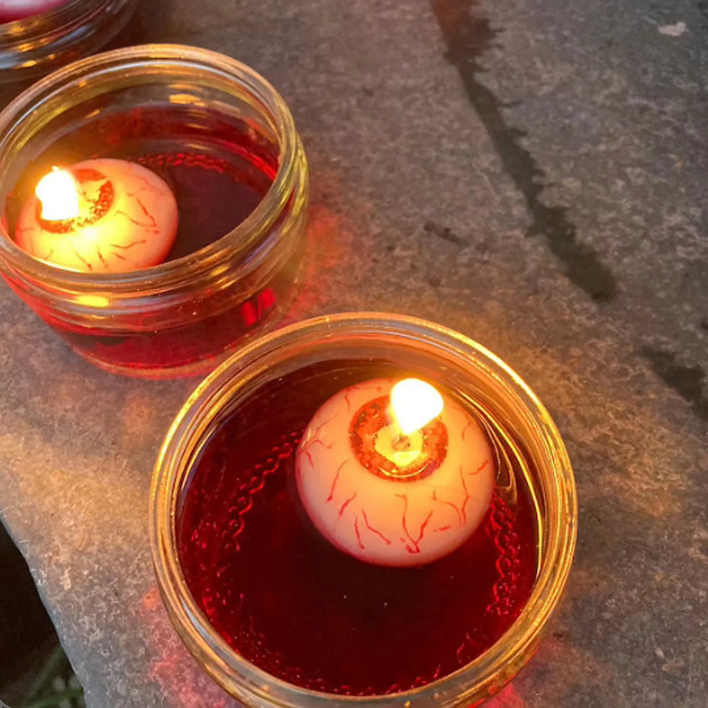 Red oval eyeball floating Halloween candle made from paraffin wax