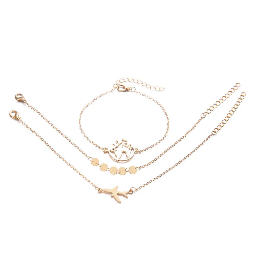 Set of three women's bohemian bracelets with heart-shaped aircraft map charms in alloy metal.
