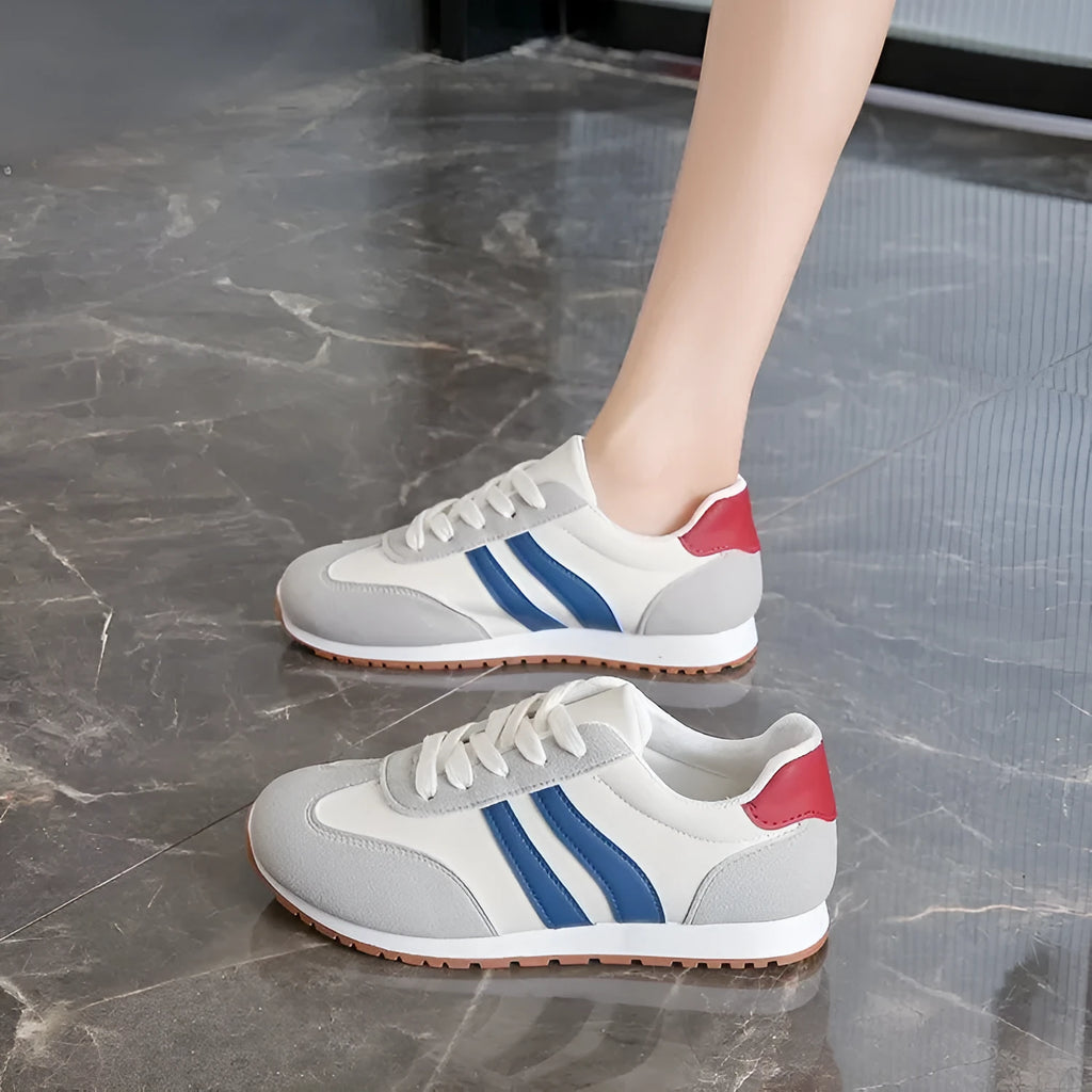 Blue and grey leisure sports shoes with Cortez stripes pattern, flat rubber sole, and round toe design