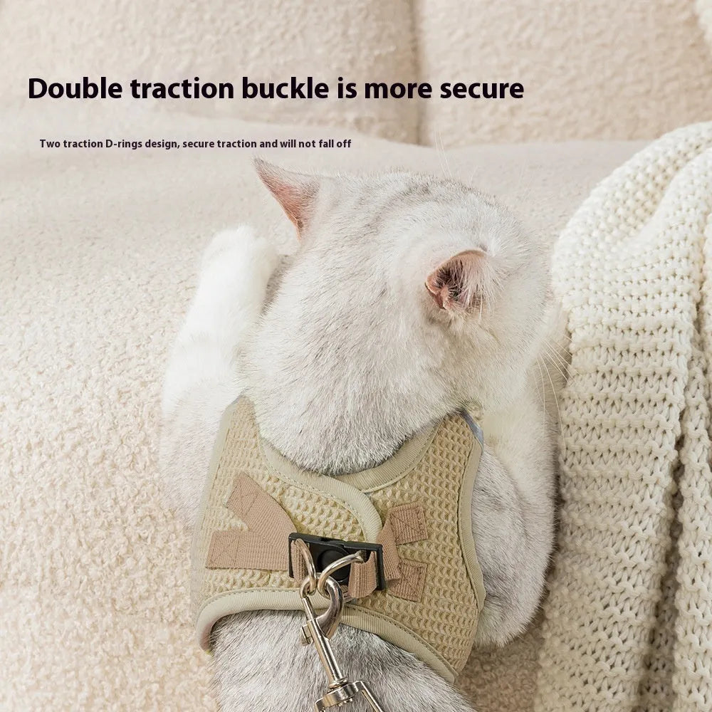 Brown waffle cloth cat harness chest strap showing adjustable sizing and hand holding rope attachment
