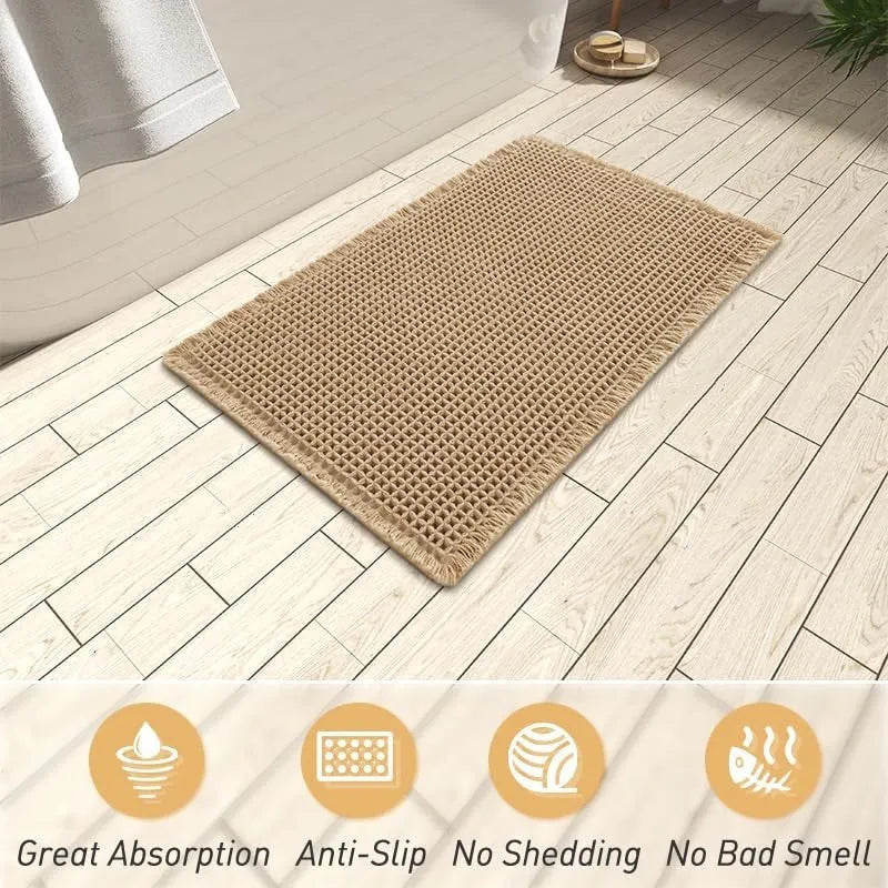 Checkered patterned non-slip absorbent bathroom floor mat in a neutral colour on tiles.