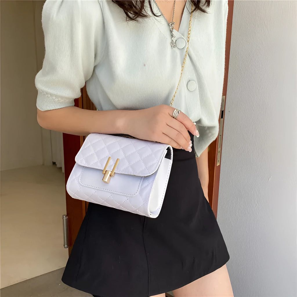 Women's black PU leather crossbody bag with diamond lattice chain detailing and adjustable shoulder strap