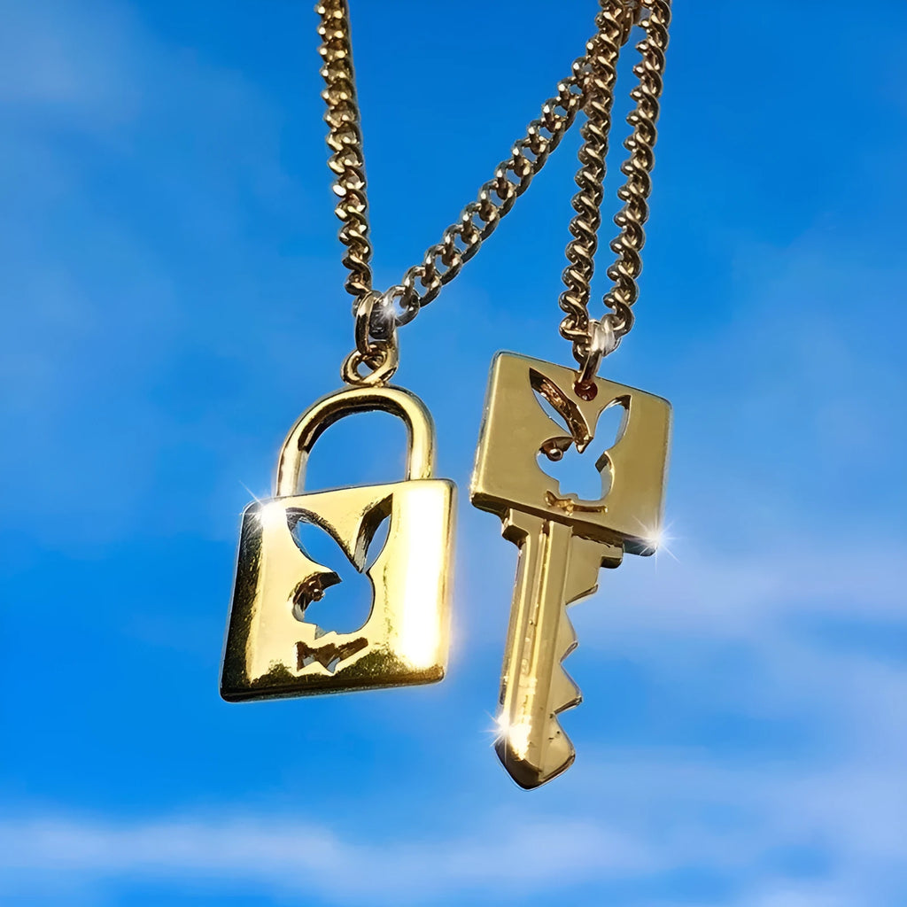 Shiny alloy key lock pendant necklace with geometric shape and electroplated finish on white background