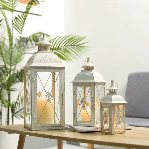 Black and white wrought iron floor-standing storm lantern with tempered glass panels in three sizes for courtyards.