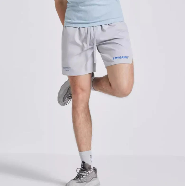 Men's four-point training shorts in a polyester blend for fitness and sports, shown in blue, black, grey, or white.