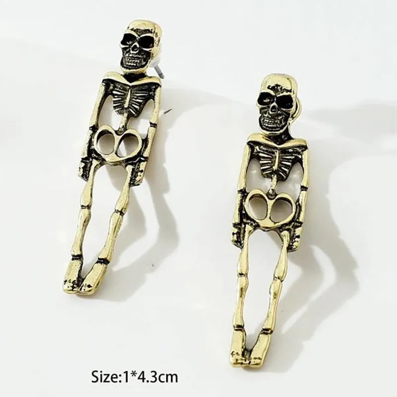 Gold and silver skull detachable stud earrings with skeleton design on white background