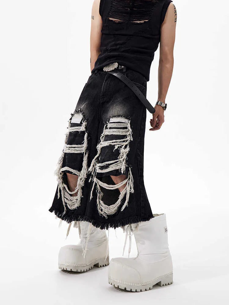 Black women's cropped wide-leg jeans with a ripped patch detail on the leg.