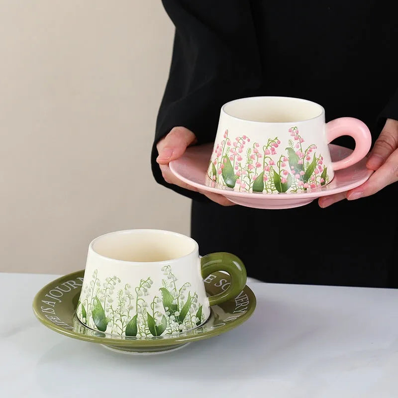Ceramic coffee cup and saucer set with two cups, two plates, and two spoons in Campanula design