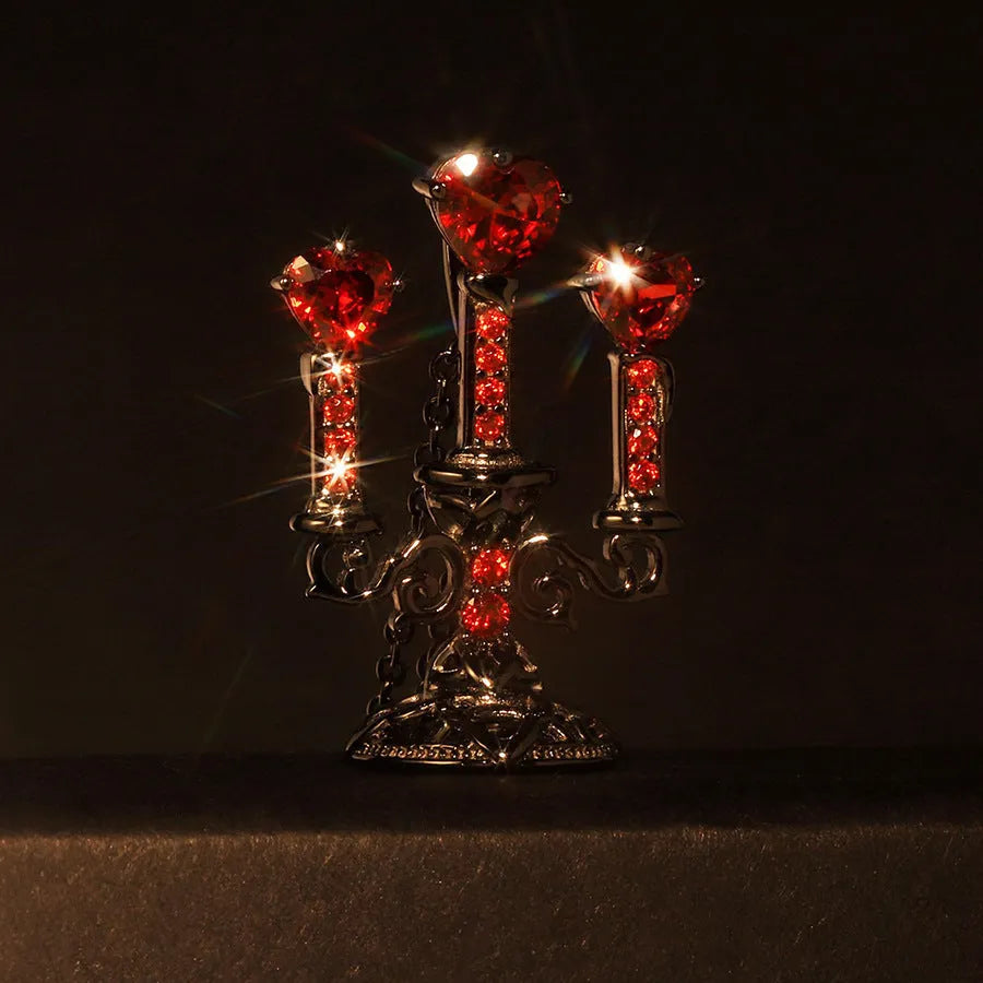 Zinc alloy gothic necklace with hollow candlestick pendant and cross chain on a dark background.