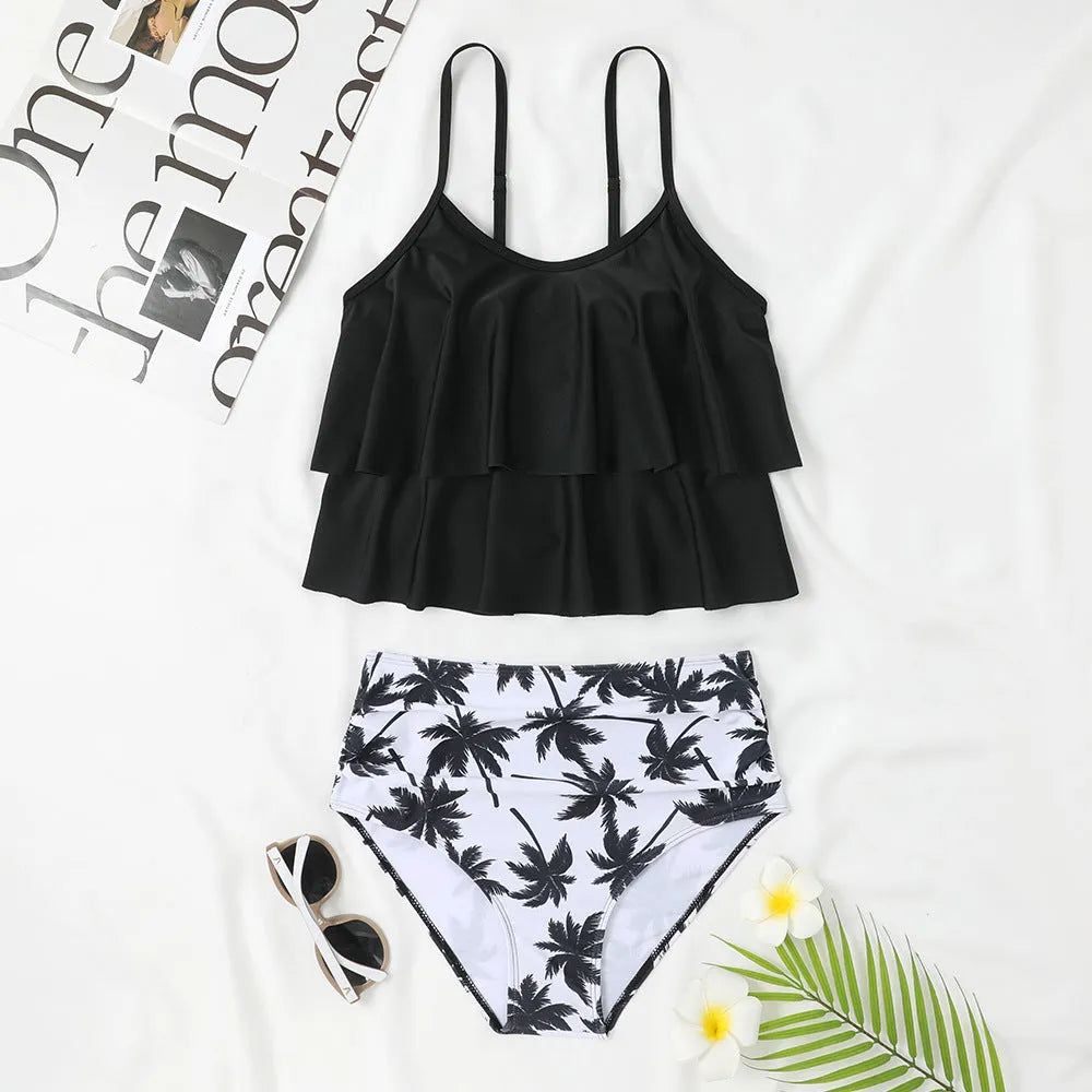 Black women's high waist swimsuit with a white coconut tree floral print on the briefs.