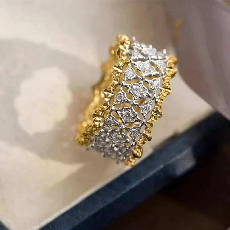 Geometric two-tone copper ring with a round zircon stone on a finger.