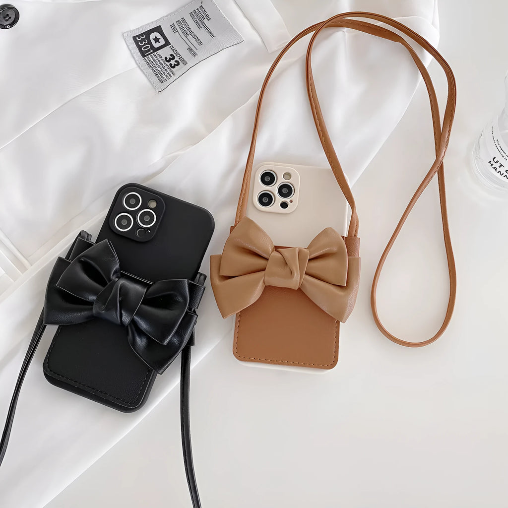 Ladies crossbody bag phone case in black with bow and strap showing iPhone in case front view