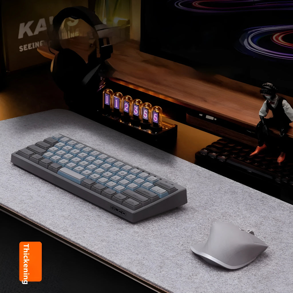 A winter warm felt cork office desk mat in a grey colour pattern, shown on a wooden desk with a mouse.