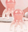 Pink octopus-shaped massage comb for periocular meridian acupressure with curved arms and storage bag