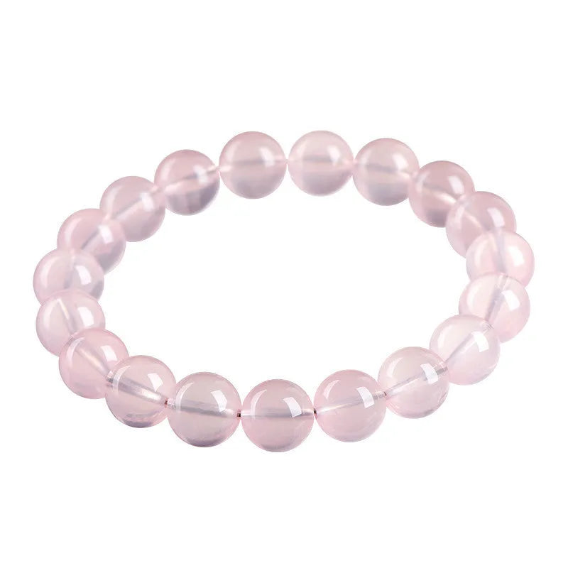 Natural starlight crystal round bead bracelet in pink with polished beads in multiple size options