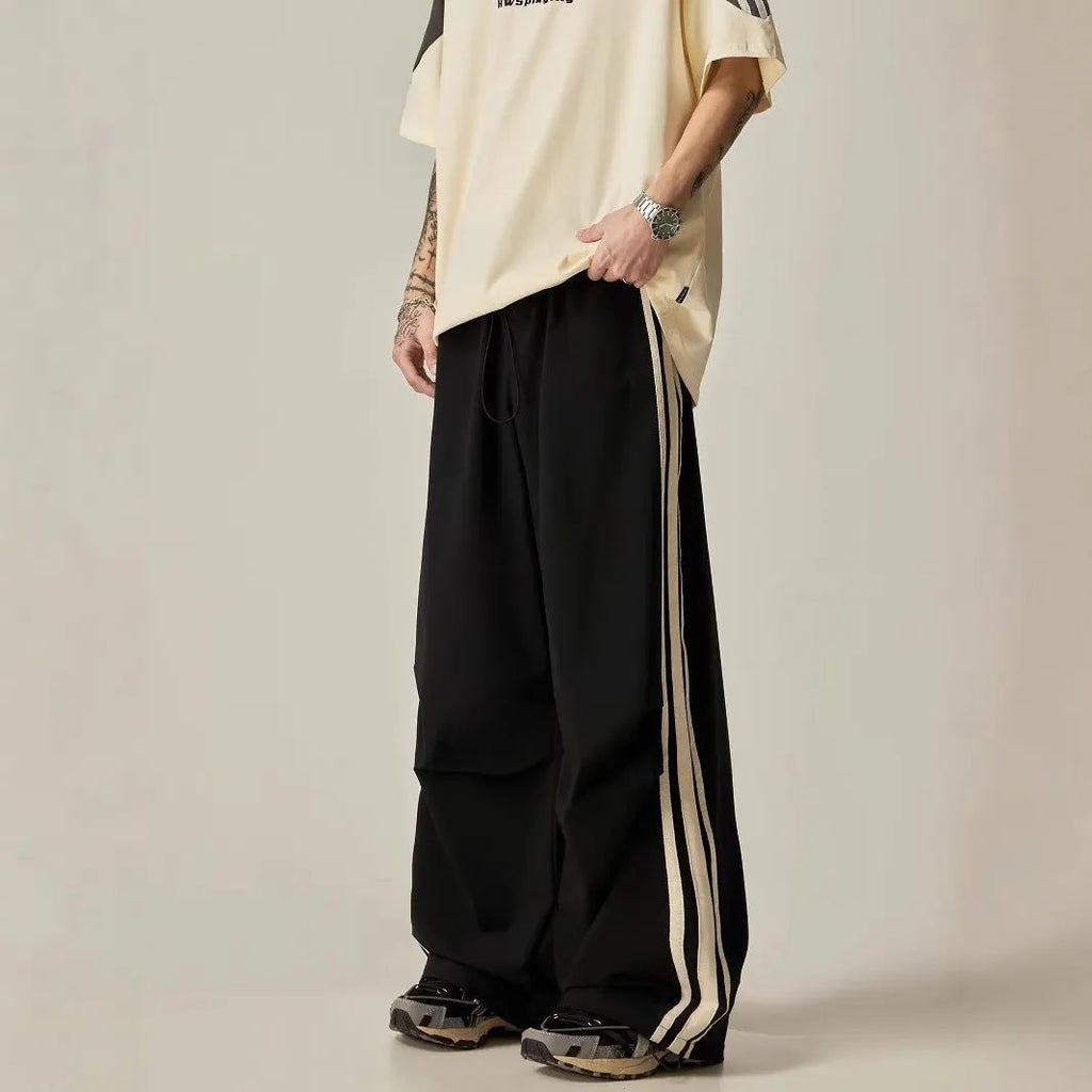 Man wearing black high-waist wide leg climbing pants made from polyester for casual leisure wear.