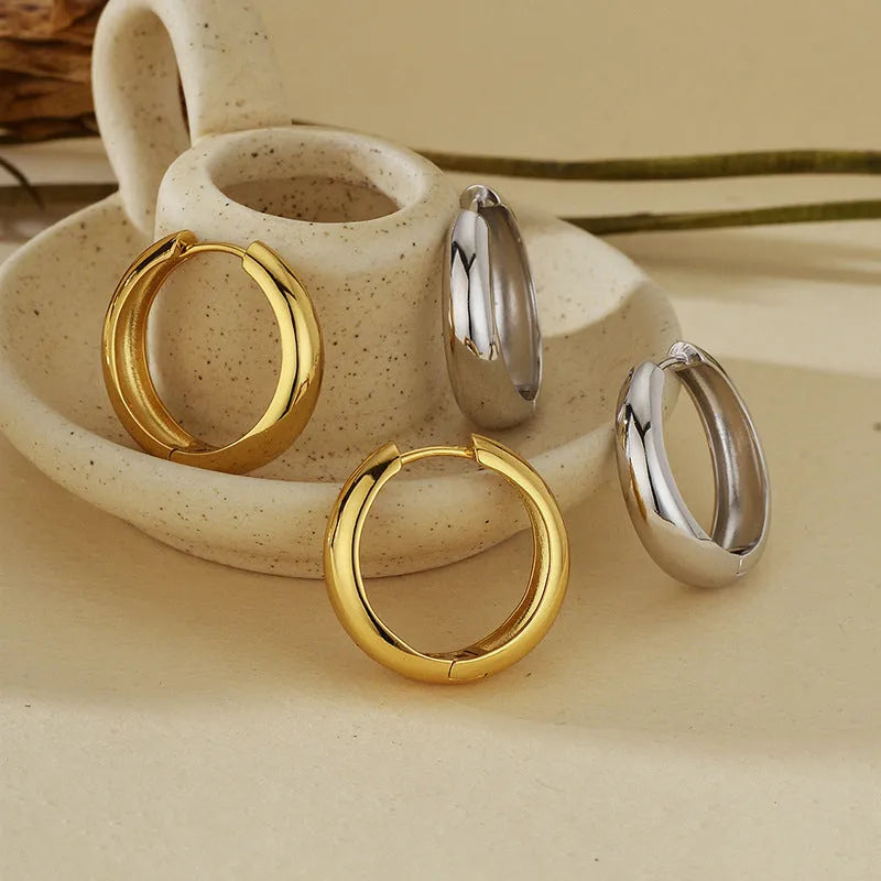 Pair of S925 sterling silver round hoop earrings with glossy electroplated finish in gold or white gold